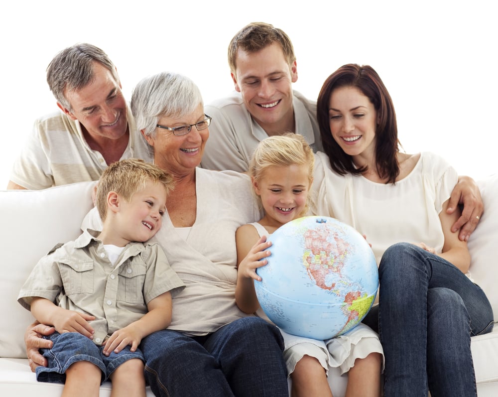 Happy big family on sofa looking at a terrestrial globe