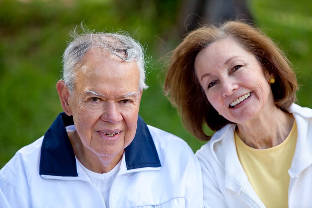 Portrait of a retired couple at the park smiling