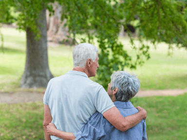 picture representing an old couple holding each other