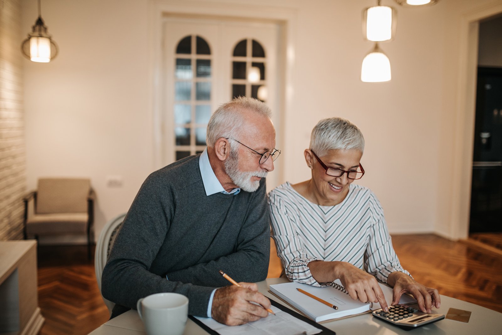 Excited couple signing mortgage documents